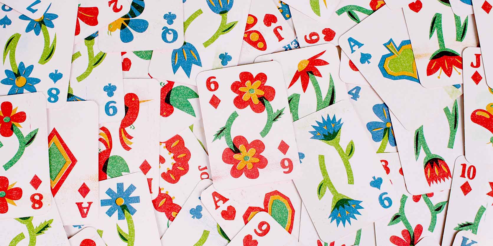 Spread of illustrated playing cards featuring risograph flowers